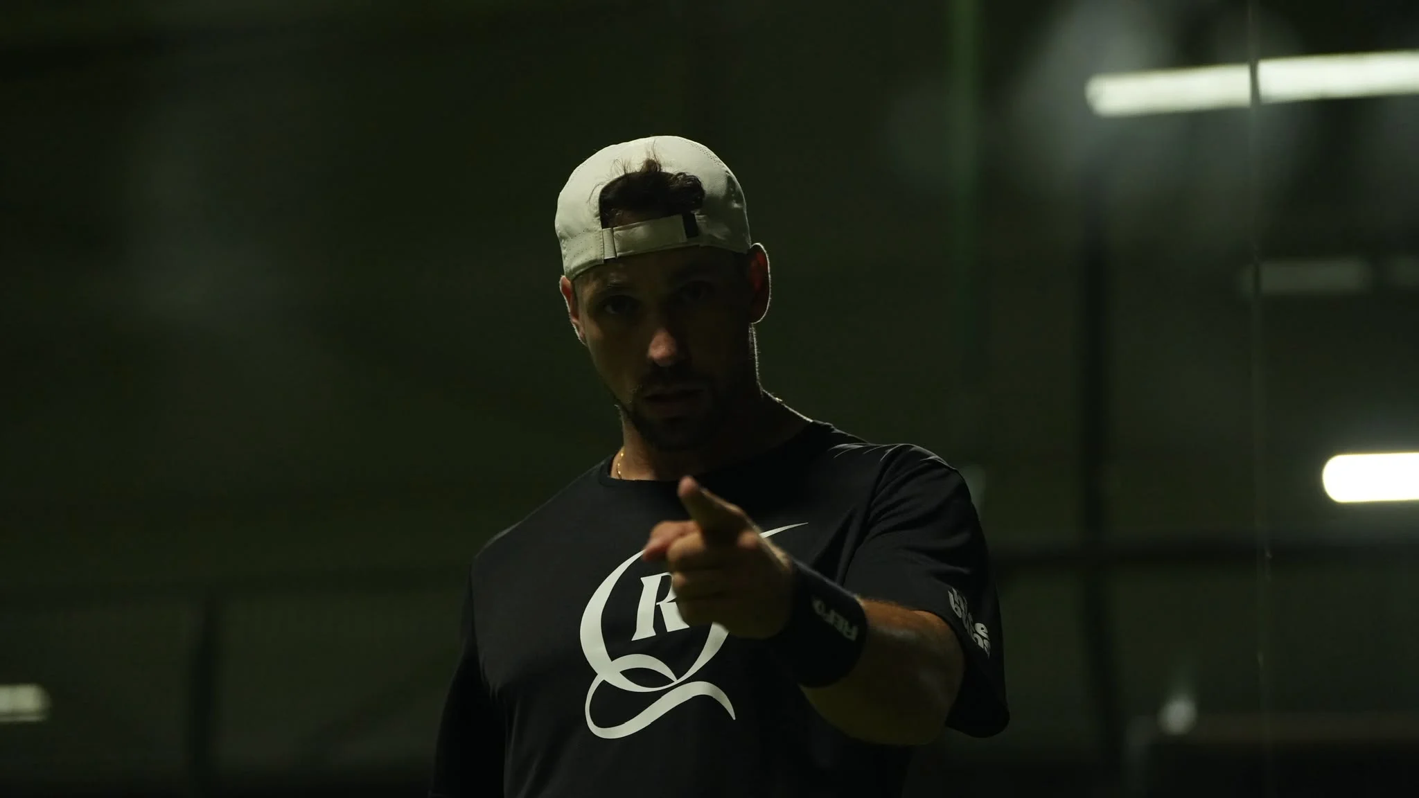 Vuk Velickovic pointing towards the camera on a padel court